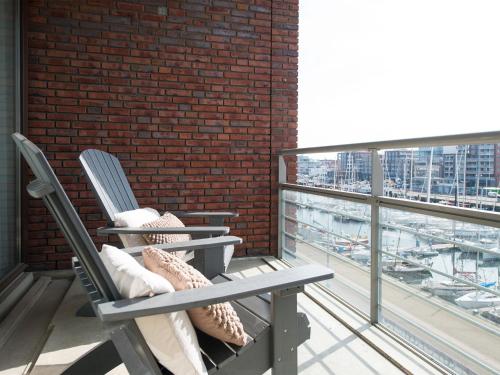 ein paar Stühle auf einem Balkon in der Unterkunft Modern apartment located on the Scheveningen coast in Scheveningen