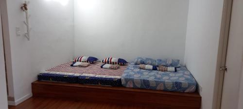 a bed with pillows on it in a room at HOMESTAY DAMAI PERDANA in Kuala Lumpur