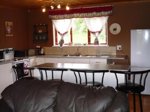 a kitchen with a couch and a table with chairs at Berghaven in Underberg