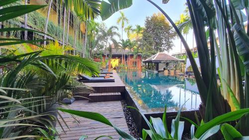 a resort with a swimming pool and some plants at Residence Indochine D'angkor in Siem Reap