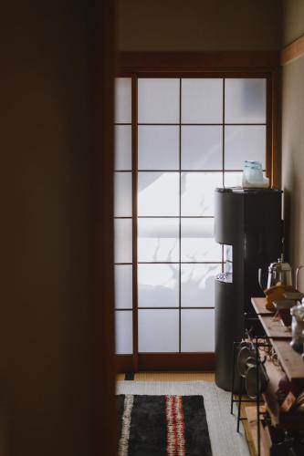 an open door to a room with a window at guesthouse SHIBAFU in Kamakura