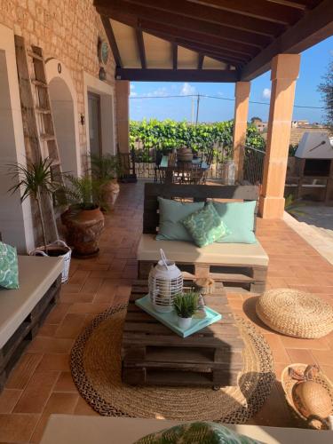 a patio with couches and a table on a patio at Ca Na Marina in Cala Llombards