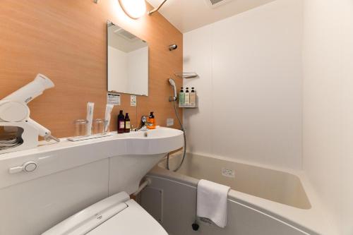 a bathroom with a white toilet and a sink at The Centurion Hotel & Spa Classic Izumo in Izumo