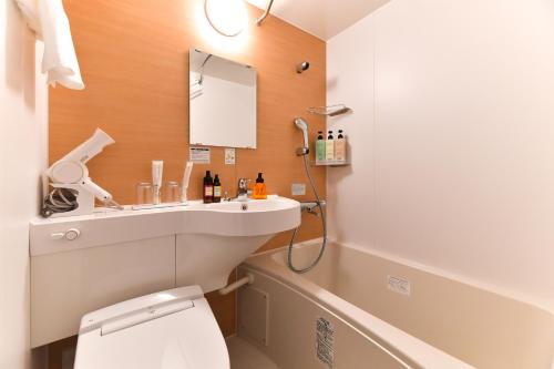 a bathroom with a sink and a toilet at The Centurion Hotel & Spa Classic Izumo in Izumo