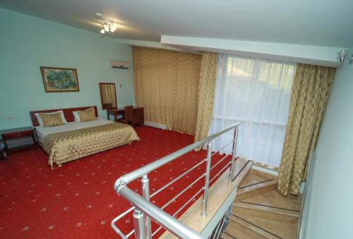 a hotel room with a bed and a balcony at Best Resort Aghveran in Arzakan