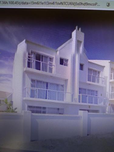 a rendering of a white apartment building at sandpiper in Jeffreys Bay