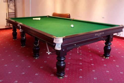 a green pool table with two balls on it at Best Resort Aghveran in Arzakan
