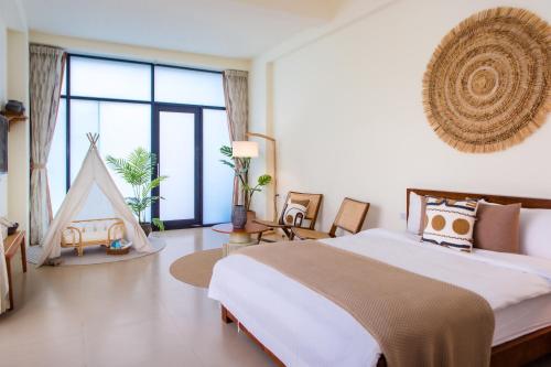 Postel nebo postele na pokoji v ubytování Taitung Rainbow Pet Friendly Maison Resort