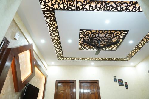 a room with a ceiling with a black and gold design at Classia Suites in Bengaluru