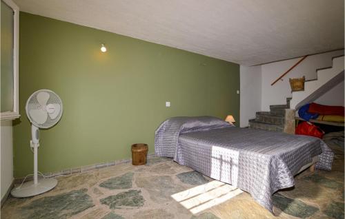 a bedroom with a bed and a fan and stairs at Awesome Apartment In San Lorenzo in San-Lorenzo