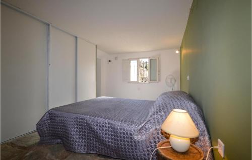a bedroom with a bed and a lamp on a table at Awesome Apartment In San Lorenzo in San-Lorenzo