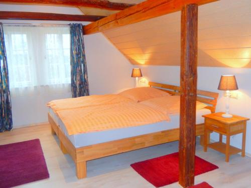 a bedroom with a canopy bed and a window at Visavis Villa Velo in Jestädt