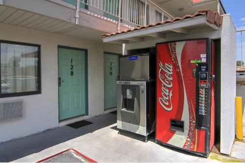 a cocacola vending machine in front of a building at Motel 6-Tempe, AZ - Broadway - ASU in Tempe