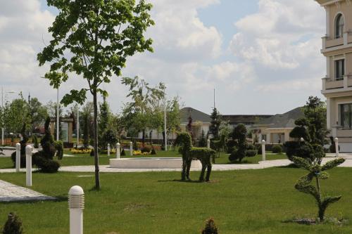 a statue of a horse in the grass in front of a building at Gabala Garden Hotel in Gabala