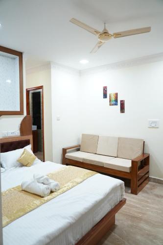 a bedroom with two beds and a ceiling fan at Classia Suites in Bengaluru