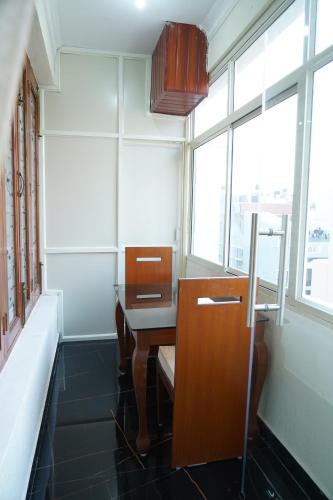 an empty room with a desk and a window at Classia Suites in Bengaluru