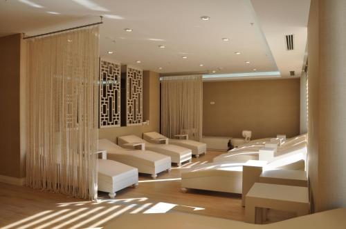 a waiting room with white couches and tables at Gabala Garden Hotel in Gabala