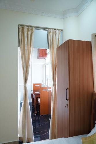 a bedroom with a bed and a room with a table at Classia Suites in Bengaluru