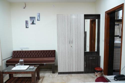 a living room with a couch and a table at Classia Suites in Bengaluru