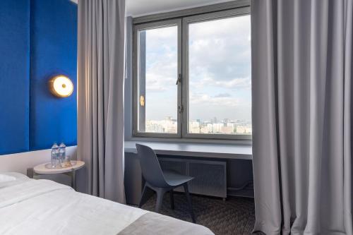 a hotel room with a bed and a window at Astrus Hotel Moscow in Moscow