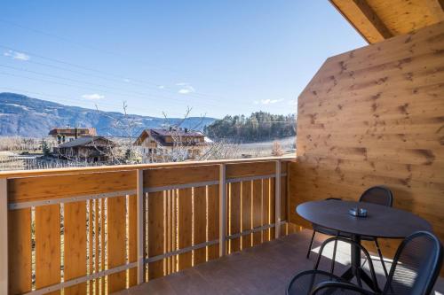 a view from the balcony of a cabin with a table and chairs at sunnig Apartment Morgensonne in Vollan