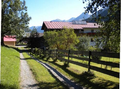 a fence in front of a house with a house at Ferienhaus Wechner in Häselgehr