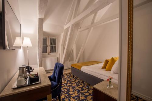 a hotel room with a bed and a mirror at Hotel Gamla Stan, BW Signature Collection in Stockholm