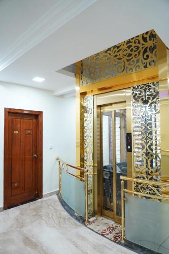 a room with a door and a wall with a mirror at Classia Suites in Bengaluru