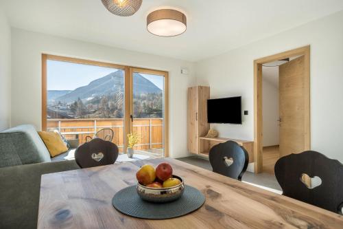 a living room with a table with a bowl of fruit at Sunnig Apartment Abendsonne in Vollan