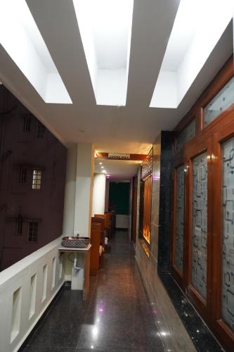 a hallway in a building with a ceiling at Classia Suites in Bengaluru