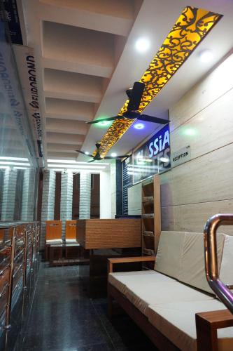 a hospital room with beds and chairs and a sign at Classia Suites in Bengaluru