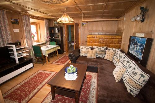 a living room with a couch and a table at Ferienhaus Wechner in Häselgehr