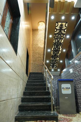 a set of stairs in a building with a chandelier at Classia Suites in Bengaluru