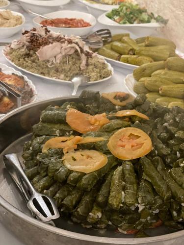 a buffet of food with cucumbers and vegetables on a table at Al Bishara Guest House in Nazareth