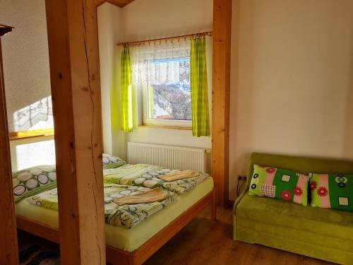 a bedroom with two bunk beds and a window at Penzión Malá Fatra u Ďurka in Žilina