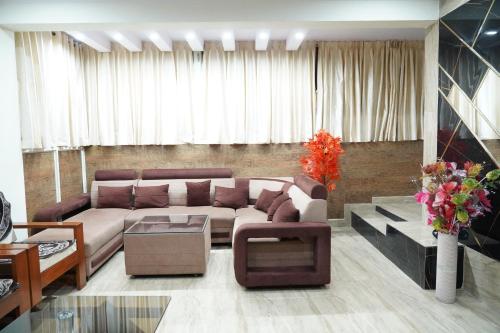 a living room with a couch and a table at Classia Suites in Bengaluru