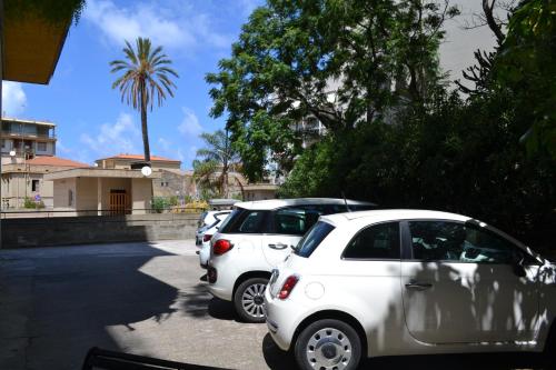a row of cars parked in a parking lot at Hotel Mediterraneo in Cefalù