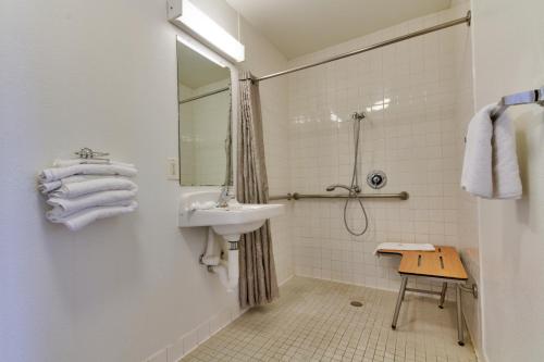 a white bathroom with a sink and a mirror at Motel 6-Irving, TX - Dallas in Irving