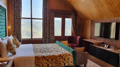 a hotel room with a bed and a window at Skyview by Empyrean in Patnitop