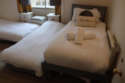 a bedroom with two beds with towels on them at The Mariners Hotel in Lyme Regis