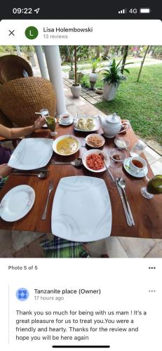 a wooden table with plates of food on it at Tanzanite place in Tangalle