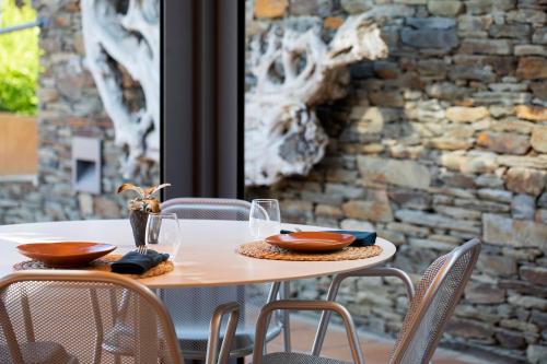 a table with glasses and napkins on top of it at Hotel Sol Ixent - Adults Only in Cadaqués