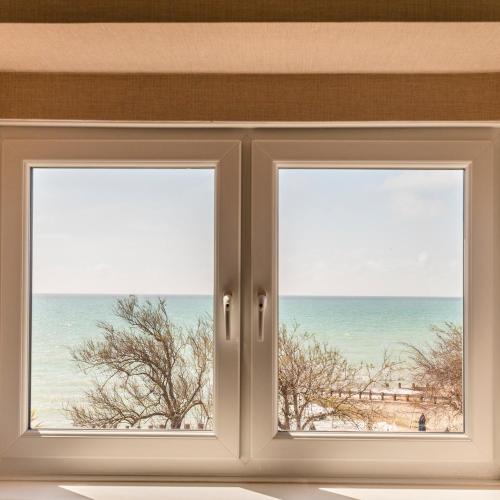 an open window with a view of the beach at The Beachcroft Hotel, BW Signature Collection in Bognor Regis