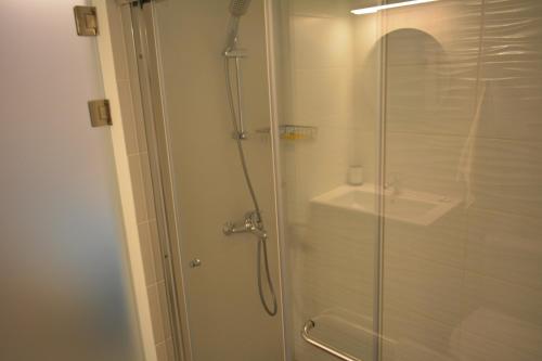 a bathroom with a shower with a glass door at Les Palmiers Sunorama Beach Apartments in Larnaka