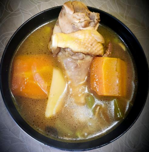 a bowl of soup with meat and vegetables in it at The Silver Spring Homestay in Darjeeling