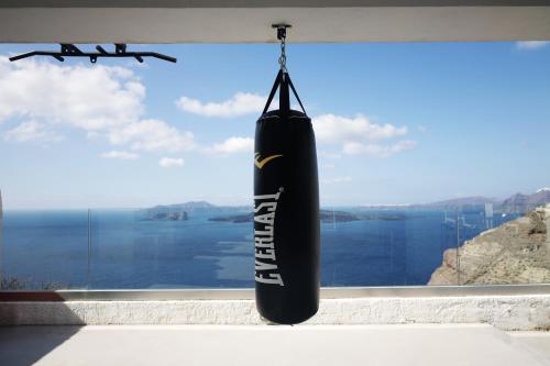 a large black inflatable raft hanging in front of a window at Caldera's Dolphin Suites in Megalokhori