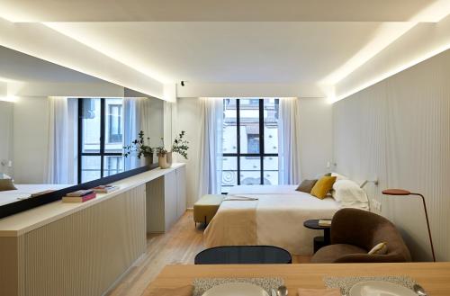 a bedroom with a bed and a table and chairs at 60 Balconies Iconic in Madrid