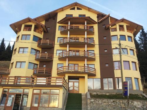 a yellow building with balconies on the side of it at HOTEL CARMINA in Ranca