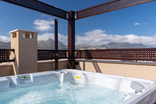a hot tub on a balcony with a view at Solemar Sicilia - Multi Suite in Palermo