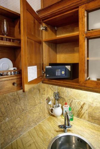 a kitchen counter with a sink and a microwave at Apartment Senamiesčio Inkaras in Klaipėda